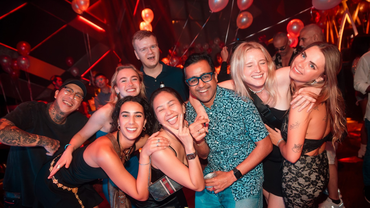 Group cheering with drinks at a famous Bangkok sports bar