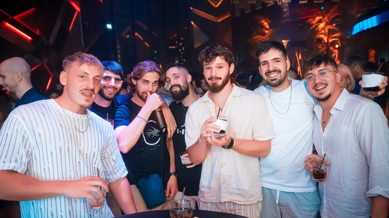 Travelers connecting and chatting at an exclusive rooftop bar in Bangkok